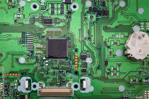 Green system board with microchips and transistors.