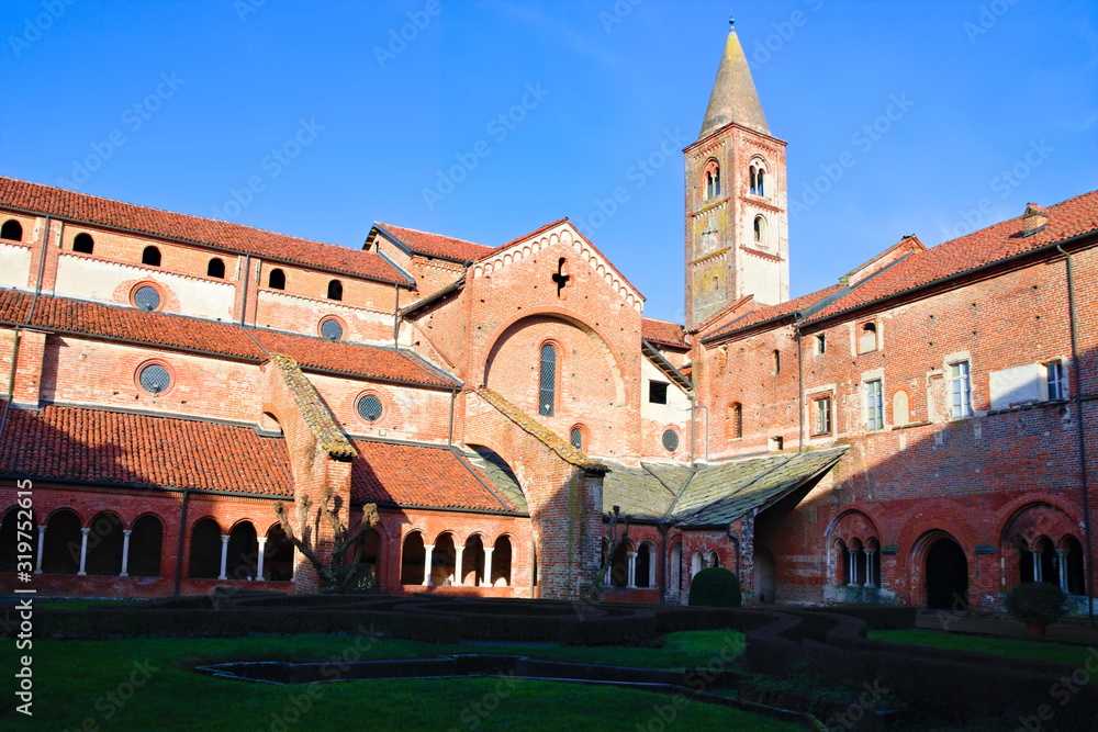 Staffarda, Piedmont, Italy - January 20, 2020: View of the cloister and internal court of the Staffarda abbey, a Cistercian monastery located near Saluzzo, founded in 1135