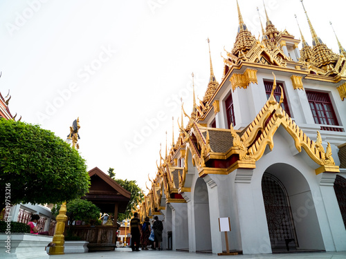 The side of Wat Ratchanatdaram Woravihara ro Loha Prasat with tourist Bangkok photo