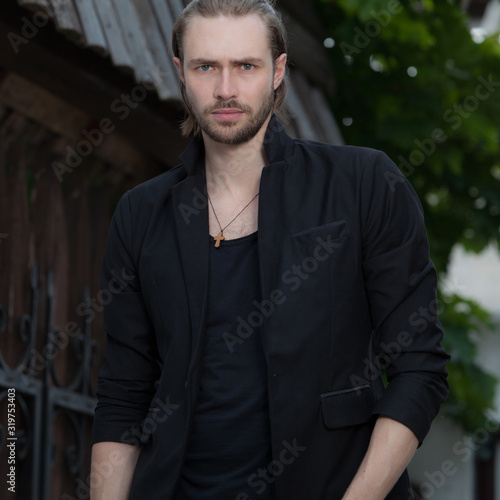 Young elegant handsome man posing outside. © Unique Vision