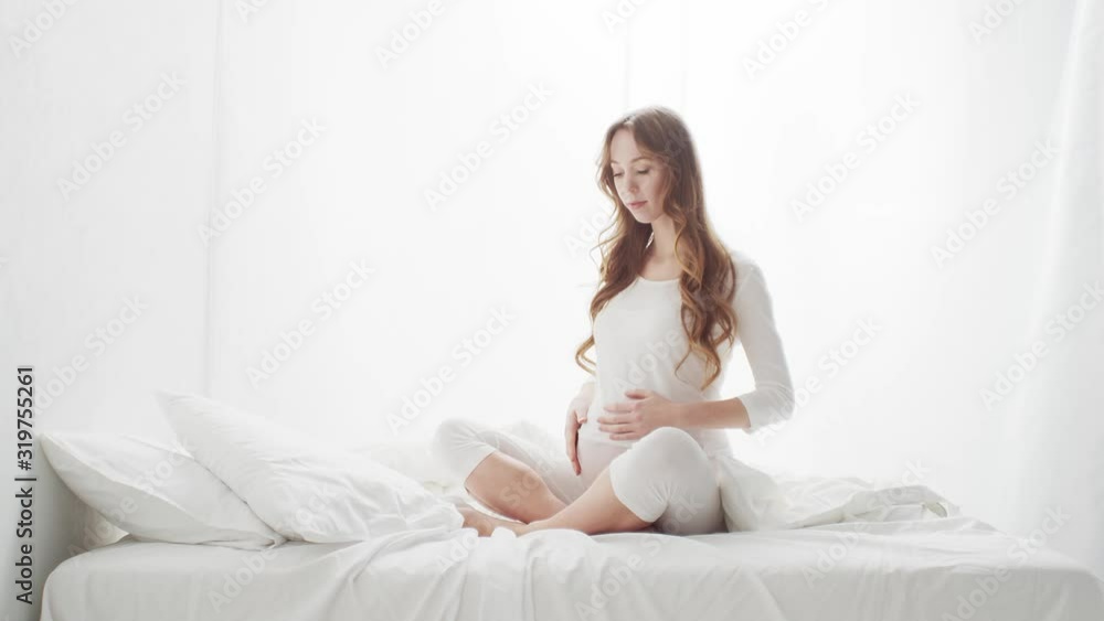 Happy pregnant woman touching her beautiful belly. Pregnancy, motherhood, and expectation concept Happy pregnant woman touching her beautiful belly. Pregnancy, motherhood, and expectation concept
