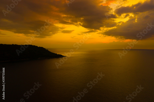 Aerial view of sunset over the sea , Phuket, Thialand. Sunset of sun setting over ocean. Tranquil idyllic scene of a golden sunset over the sea with reflection.