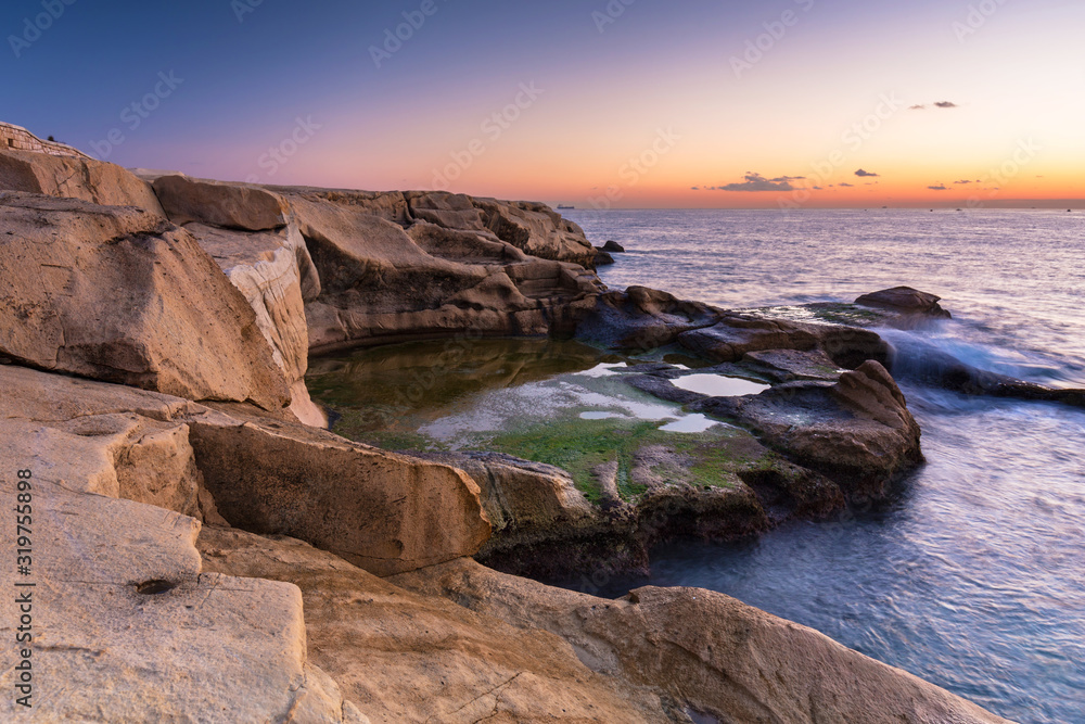Rocky coastline of Malta and Mediterranean Sea at dawn