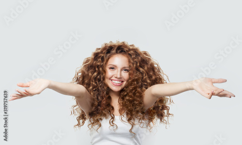 Beautiful Happy woman with open hands having fun. Welcome concept photo