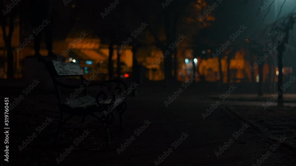 Bench in a park at night low light dark and moody Bench in a park at night low light dark and moody