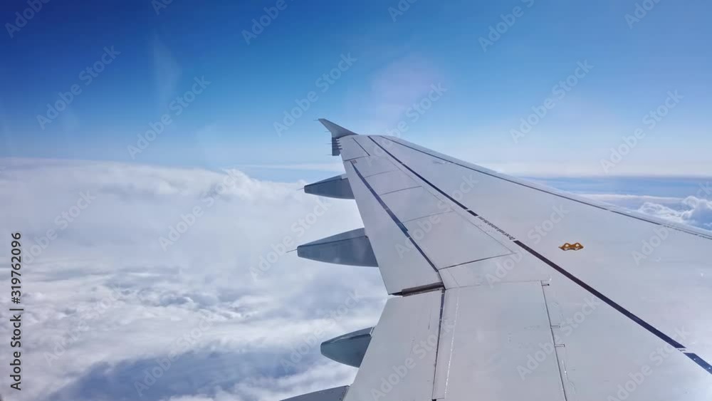 Airplane flies over the white clouds Airplane flies over the white clouds