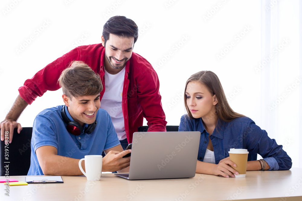 Creative people looking at project plan laid out in office. Mixed race business associates discussing new project plan in modern office. Creative people looking at project plan laid out in office. Mixed race business associates discussing new project plan in modern office.