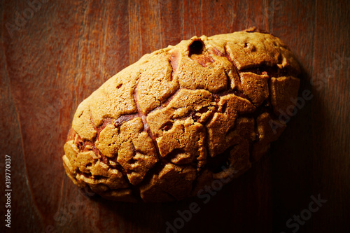 Sweet black sugar bread on wooden background  photo