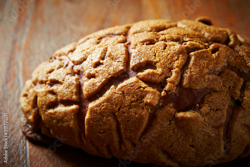 Sweet black sugar bread on wooden background  photo