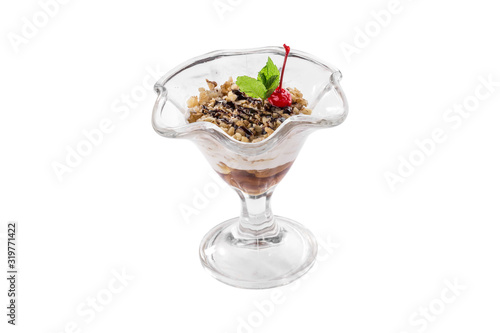 Glass of fruit and yogurt parfait with peanuts and cherry isolated on white background