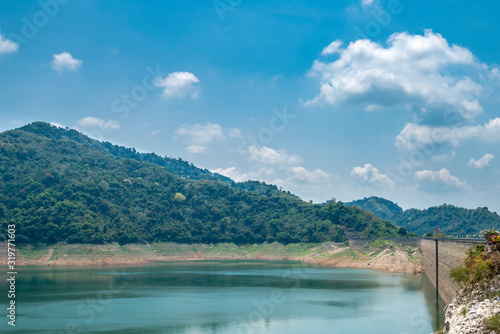 Beautiful view water in lake and high mountain with blue cloudy sky and ridge wall behind khun dan prakan chon dam in nakhon nayok province thailand