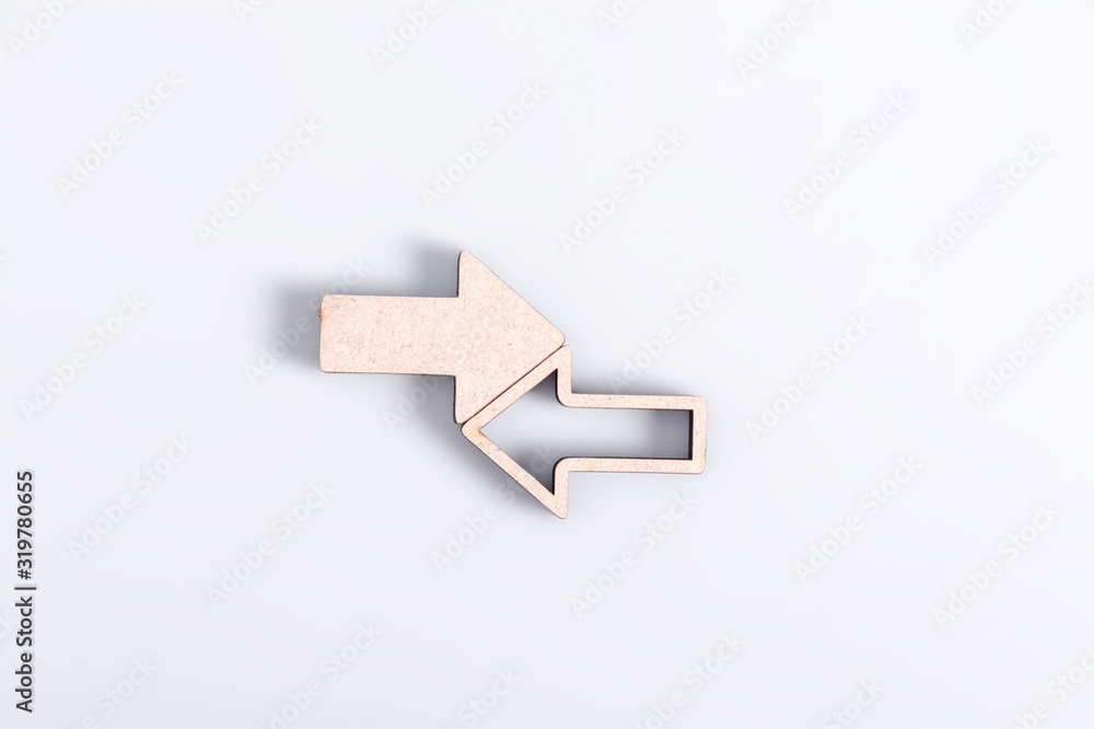 Arrows directed in opposite directions on a light background. Collision of something. Arrows directed in opposite directions on a light background. Collision of something.