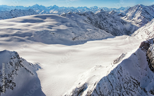Mountain peaks ridge and glacier in winter swiss alps helicopter view