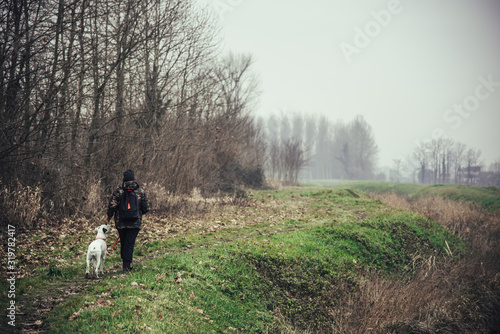 Girl and her dog walking in a rural scene