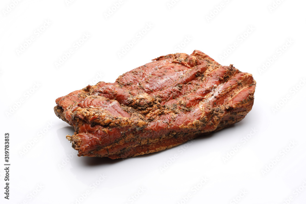 Smoked bacon in herbs in one piece. Isolated on a white background. Smoked bacon in herbs in one piece. Isolated on a white background.