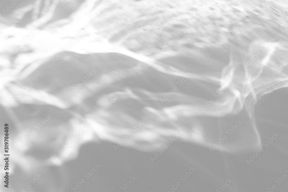 Obraz premium Water texture overlay effect for photo and mockups. Organic drop diagonal shadow and light caustic effect on a white wall.