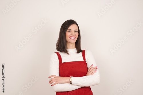 Mad crazy woman clenches teeth angrily, being annoyed with coming noise, dressed in fashionable clothes, isolated over gray background. Negative feeling concept.