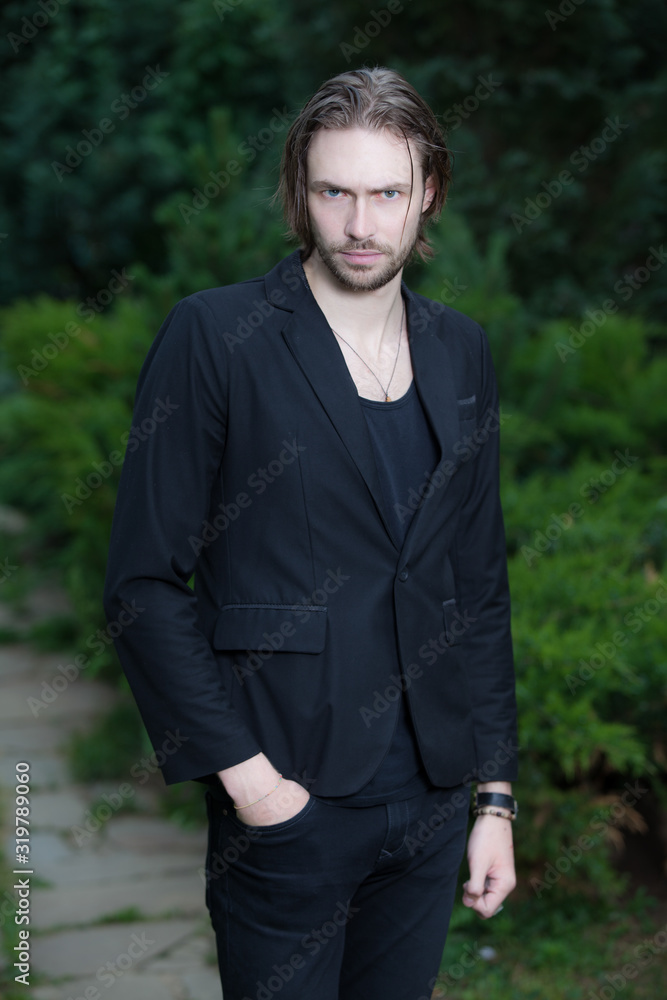 Young elegant handsome man posing outside. Young elegant handsome man posing outside.