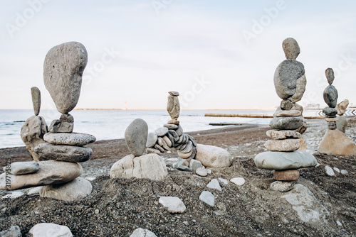 Figures of stones on the beach near the sea. Sea background and stone figures.