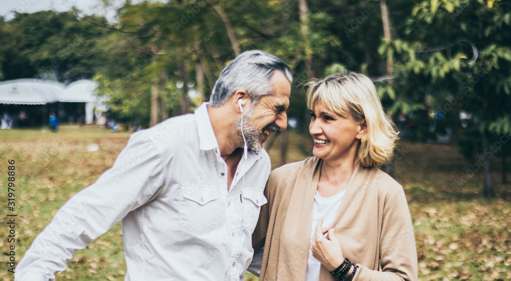 Fototapeta premium Lovely senior elderly happy couple man and woman with big laughing in romantic moment. Warm heart marriage and lover bonding and relationship. Husband and wife in love. Retired people photo concept...