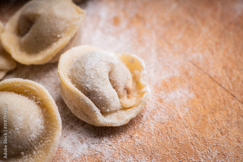 Raw dumplings in flour on the table. Russian national food. Selective focus. Raw dumplings in flour on the table. Russian national food. Selective focus.