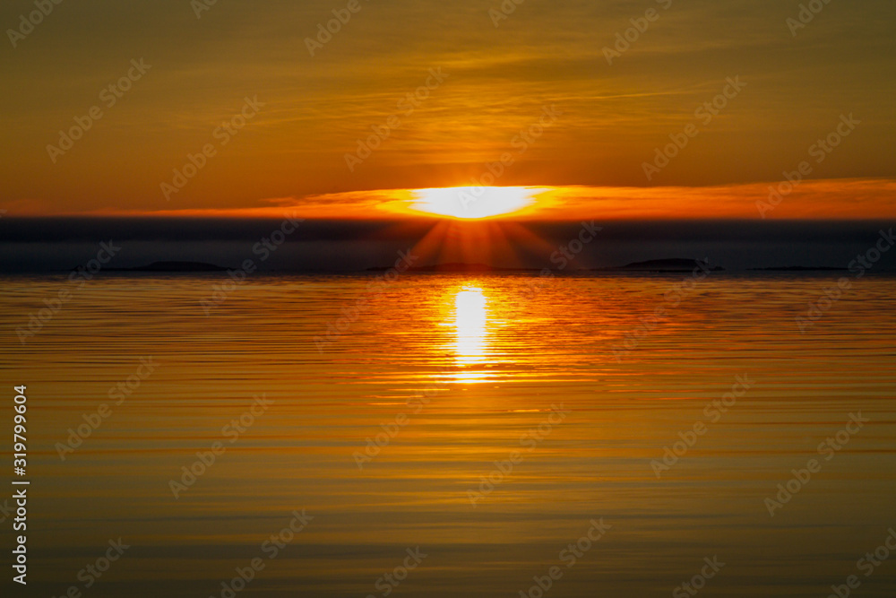 Sunset over the ocean coastline during the golden hour.