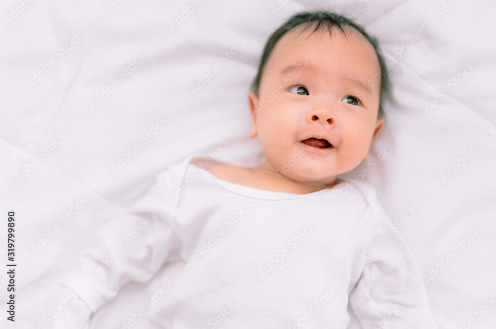Smiling baby boy lying on a white bed, Family morning at home,Children hygiene. Smiling baby boy lying on a white bed, Family morning at home,Children hygiene.