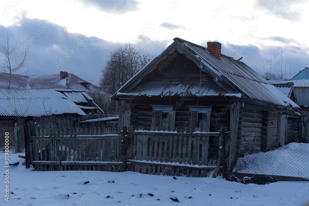 Wooden house in a small village in winter