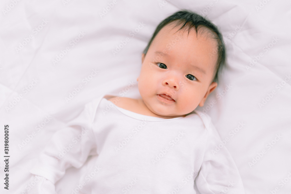Smiling baby boy lying on a white bed, Family morning at home,Children hygiene. Smiling baby boy lying on a white bed, Family morning at home,Children hygiene.