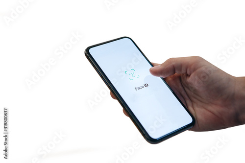 Obraz na płótnie Person uses face id on cell phone. Hand with a phone on a white background w salonie