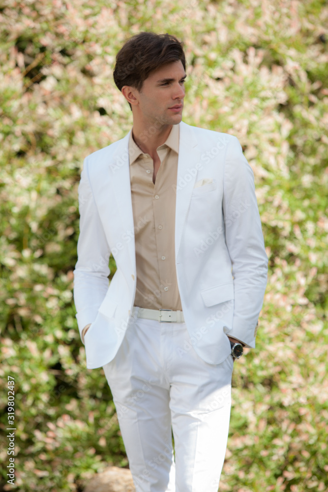 Young elegant handsome man posing outside. Young elegant handsome man posing outside.
