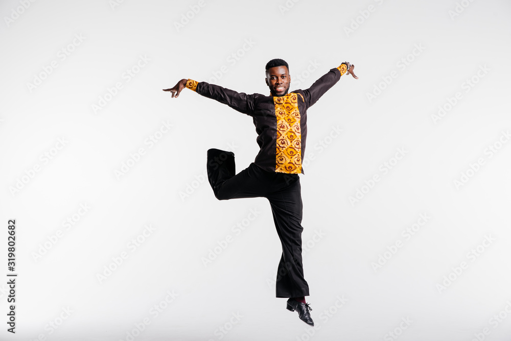 Afro american dancer on white background flies in jump. Dance school concept. Fitness concept, youth and health Afro american dancer on white background flies in jump. Dance school concept. Fitness concept, youth and health