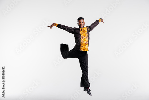 Afro american dancer on white background flies in jump. Dance school concept. Fitness concept, youth and health