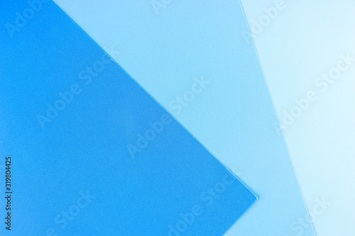 Blue background. Three separate shades of the blue