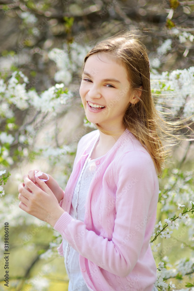 Adorable little girl in blooming apple tree garden on beautiful spring day. Adorable little girl in blooming apple tree garden on beautiful spring day.