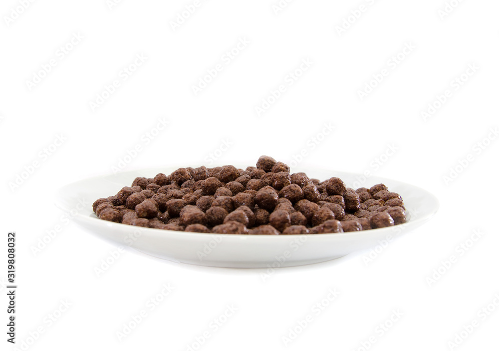 dry breakfast in a plate on a white background. Chocolate balls. dry breakfast in a plate on a white background. Chocolate balls.