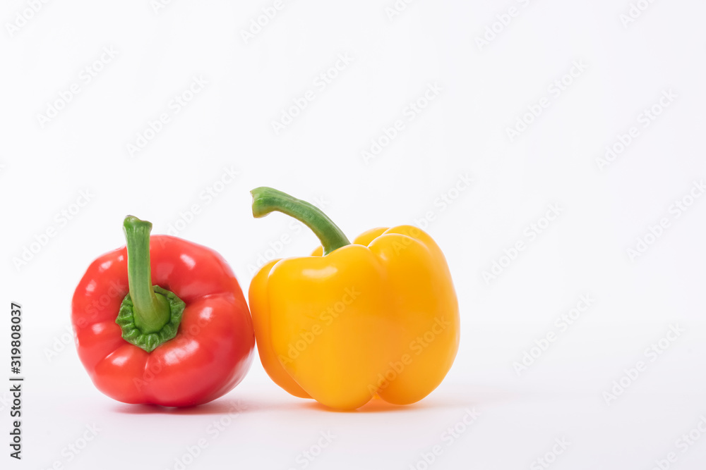 Red and yellow bell pepper in a light background Red and yellow bell pepper in a light background