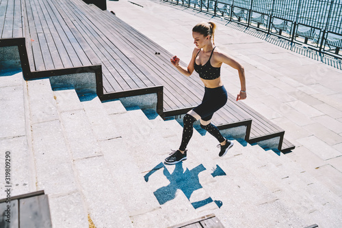 Sport woman doing workout running up stairs