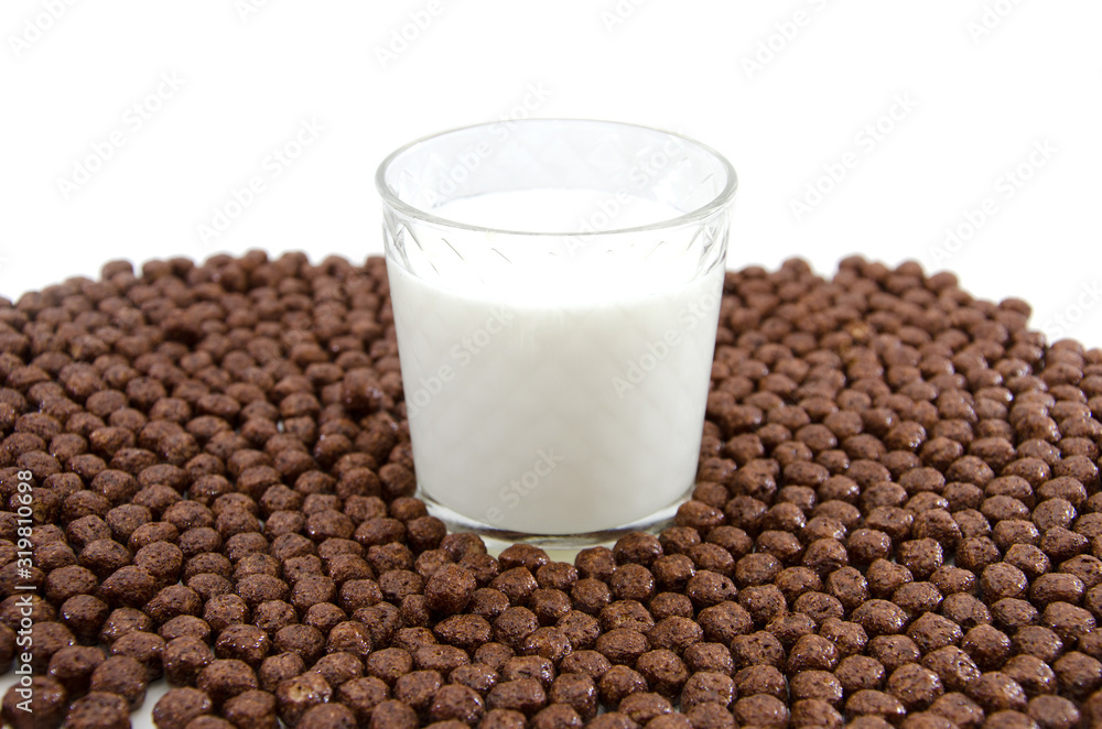 glass of milk and chocolate balls on white. Cereal. glass of milk and chocolate balls on white. Cereal.