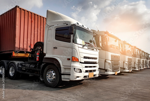 Semi Trailer Trucks the Parking lot at The Sunset Sky. Delivery Trucks. Cargo Shipping. Lorry. Industry Freight Truck Logistics Cargo Transport Concept.	