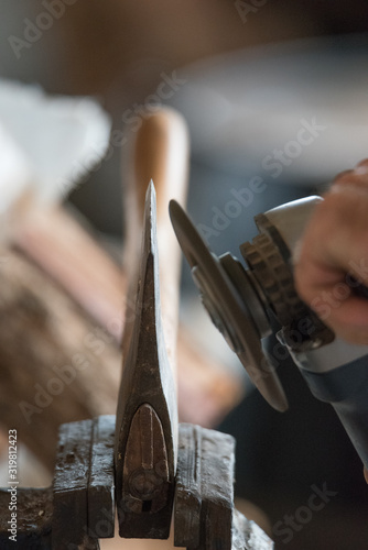 Man sharpening axe blade