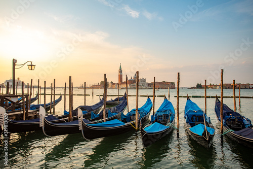Gondolas of Venice Italy in the morning against the backdrop of sunrise © Sergei Malkov