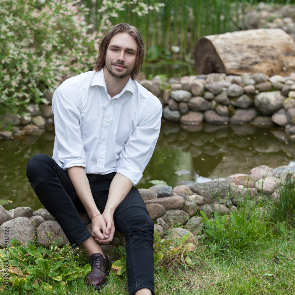 Young elegant handsome man posing outside. Young elegant handsome man posing outside.