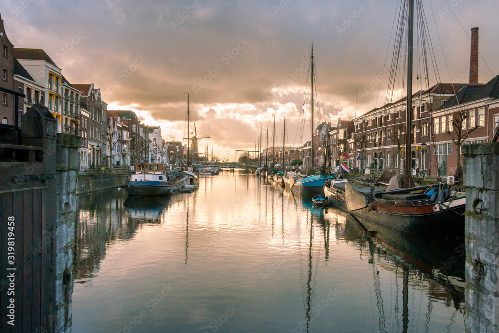 Photo of the historic Delfshaven with beautiful colored clouds in Rotterdam, and is the birthplace of the sea hero Piet Hein