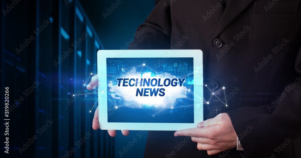 Young business person working on tablet and shows the inscription: TECHNOLOGY NEWS Young business person working on tablet and shows the inscription: TECHNOLOGY NEWS