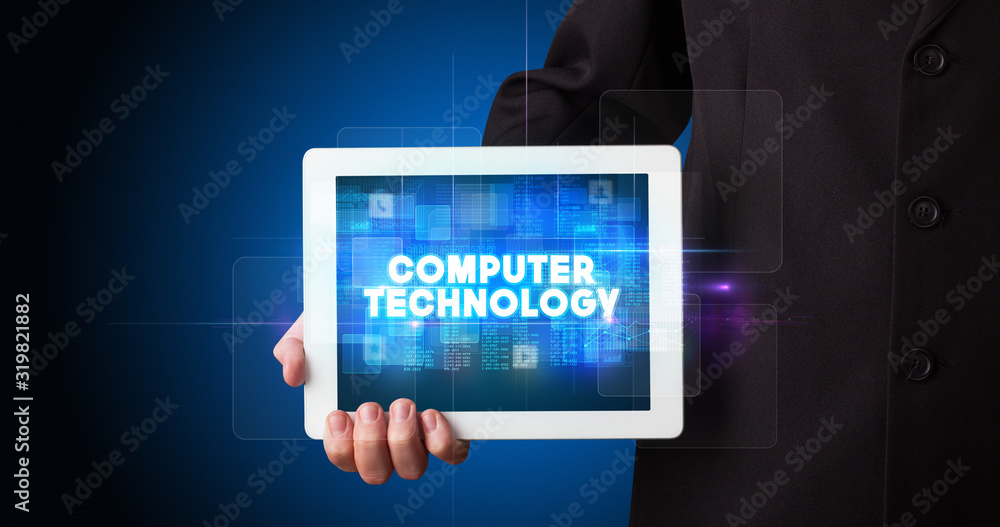 Young business person working on tablet and shows the inscription: COMPUTER TECHNOLOGY Young business person working on tablet and shows the inscription: COMPUTER TECHNOLOGY