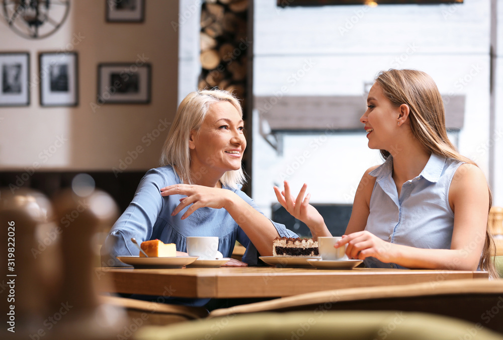 Mother and her adult daughter spending time together in cafe Mother and her adult daughter spending time together in cafe