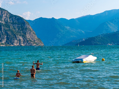 Lago di Garda in northern Italy, family tourism boats, crystal clear water, summer holidays vacations
