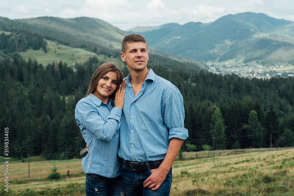Young couple in mountains smiling