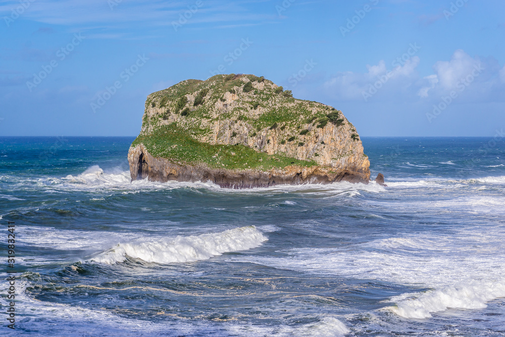 Aquech isle next to Gaztelugatxe, small isle with famous San Juan hermitage located on Bay of Biscay of the northeast Atlantic Ocean in Spain Aquech isle next to Gaztelugatxe, small isle with famous San Juan hermitage located on Bay of Biscay of the northeast Atlantic Ocean in Spain